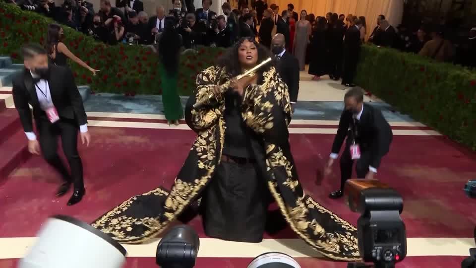 Lizzo plays flute on Met Gala red carpet | Reuters