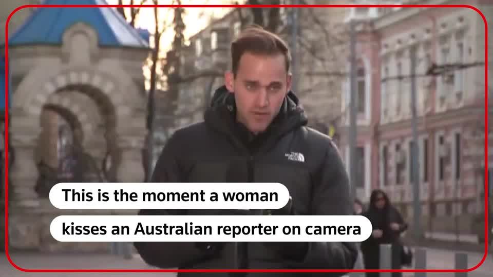 Australian news reporter gets a kiss on camera