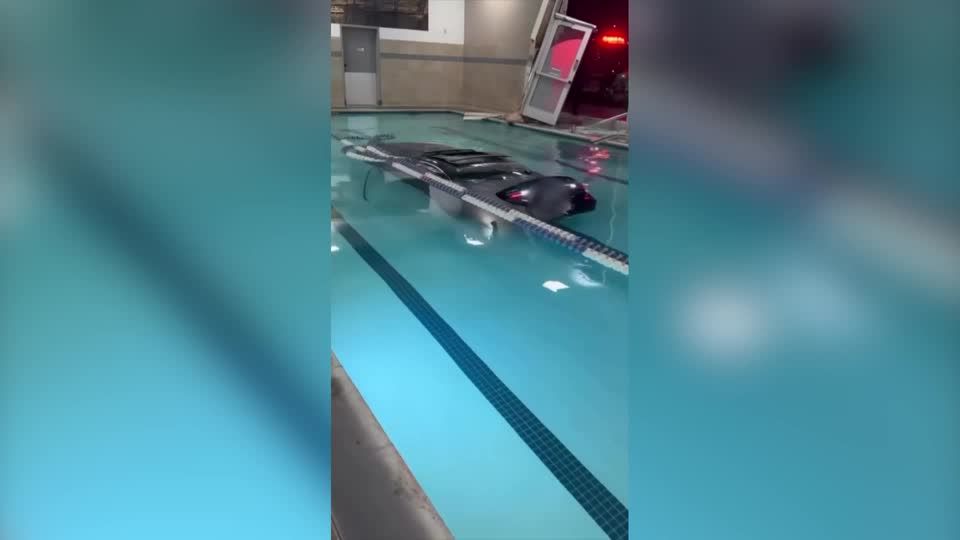 California driver safe after car plunges into fitness center pool | Reuters