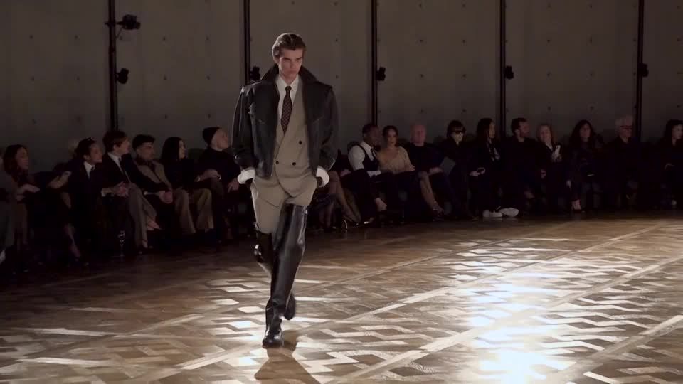 Saint Laurent flaunts thigh-high boots at Paris menswear show | Reuters