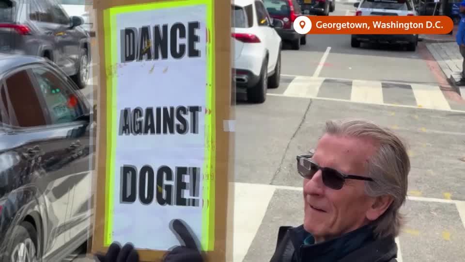 Anti-Musk protesters dance outside Washington DC Tesla showroom | Reuters