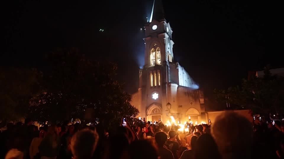 Catholics in Brazil mark start of Holy Week with torch procession | Reuters