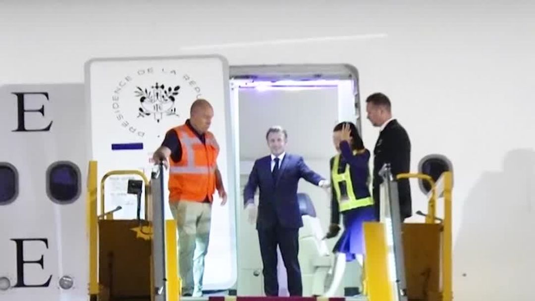Macron's face appears to be shoved by wife in Vietnam | Reuters