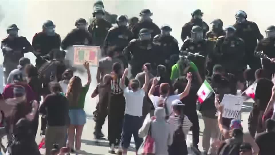 Protesters and police officers face off on LA freeway | Reuters