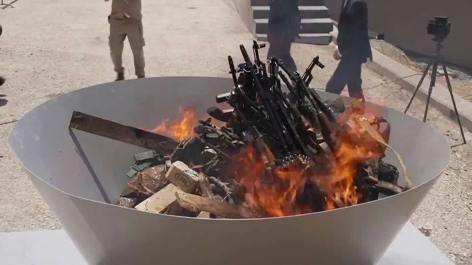 PKK fighters in Iraq burn weapons in disarming ceremony | Reuters