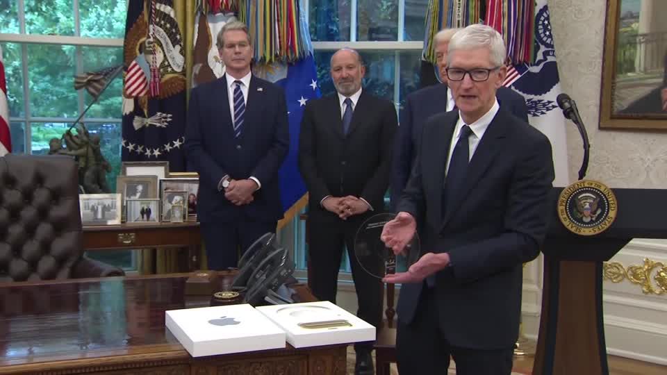 Apple CEO Tim Cook gifts Trump a plaque with a 24-karat gold base | Reuters