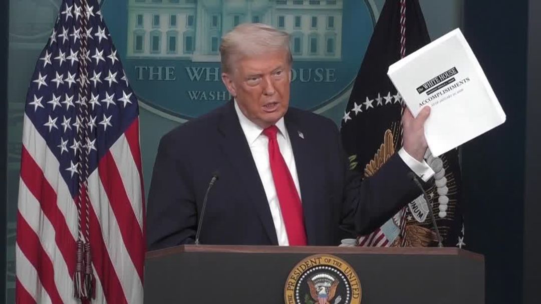 Trump tosses stack of first-year accomplishments on the floor | Reuters