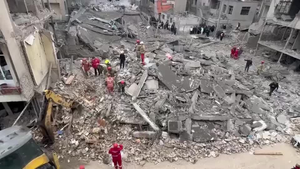 Rescuers recover bodies from rubble after a missile strike in Tehran ...