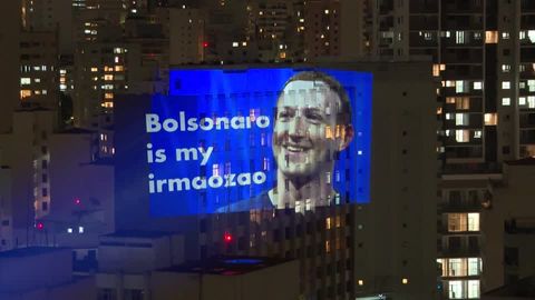 Anonymous artist projects protest images in Brazil ahead runoff | Reuters